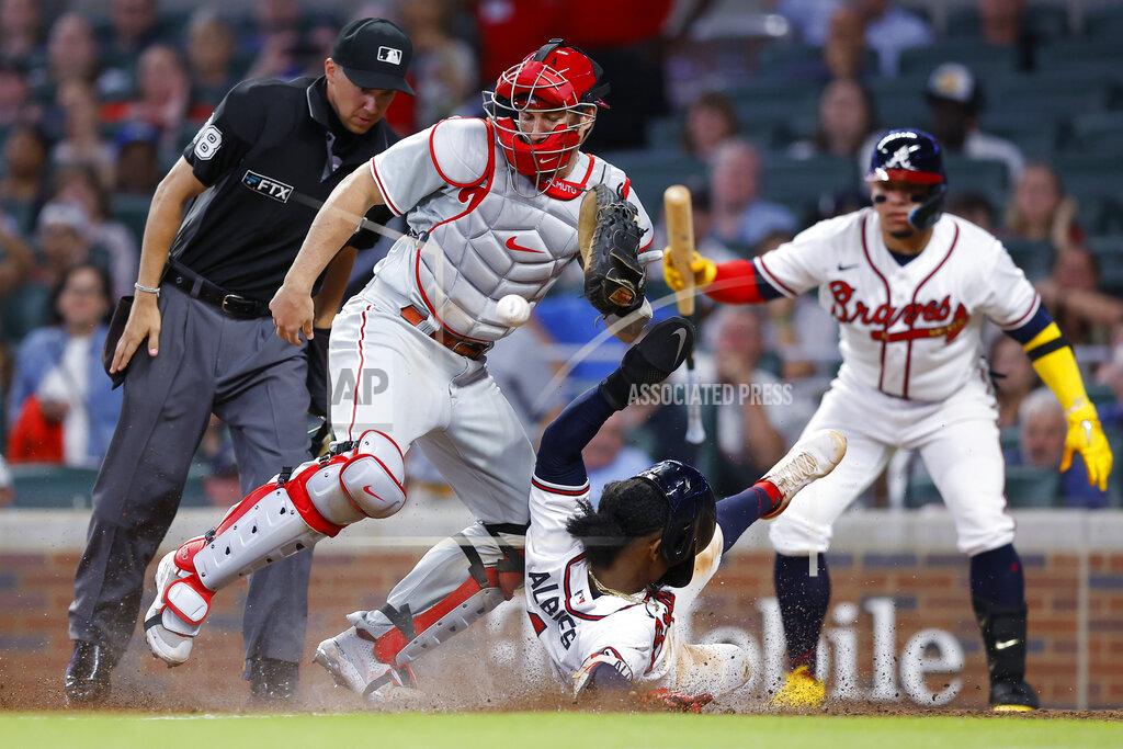 Todd Kirkland Atlanta Braves Ozzie Albies slides into home to score as the ball gets away from Philadelphia Phillies catcher J.T. Realmuto in the sixth inning of a baseball game, Tuesday, May 24, 2022, in Atlanta. (AP Photo/Todd Kirkland)