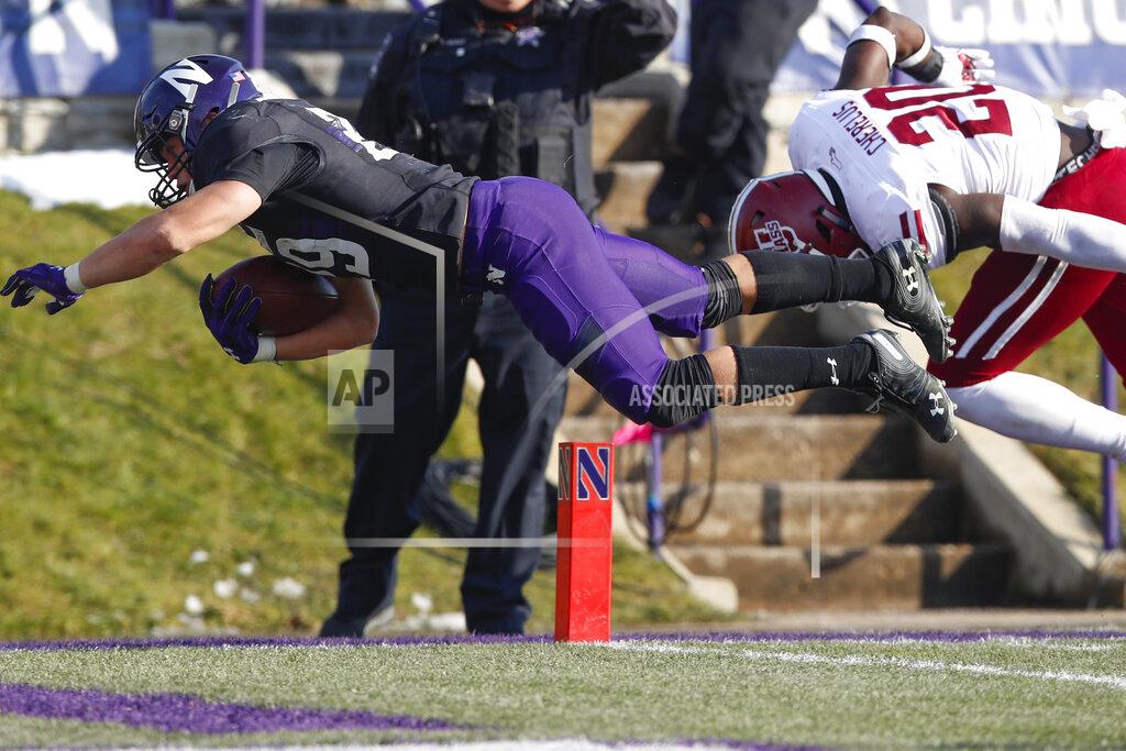 Jim Young Northwestern's Evan Hull, left, scores a touchdown after being hit by Massachusetts's Claudin Cherrelus during the second half of an NCAA college football game Saturday, Nov. 16, 2019, in Evanston, Ill. (AP Photo/Jim Young)