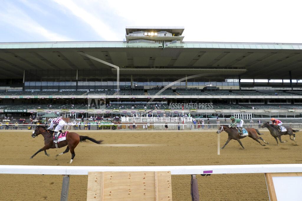 Seth Wenig Tiz the Law (8), with jockey Manny Franco up, crosses the finish line ahead of Dr Post (9), with jockey Irad Ortiz Jr. up, and Max Player (3), with jockey Joel Rosario up, in front of an empty grandstand to win the152nd running of the Belmont Stakes horse race, Saturday, June 20, 2020, in Elmont, N.Y. (AP Photo/Seth Wenig)