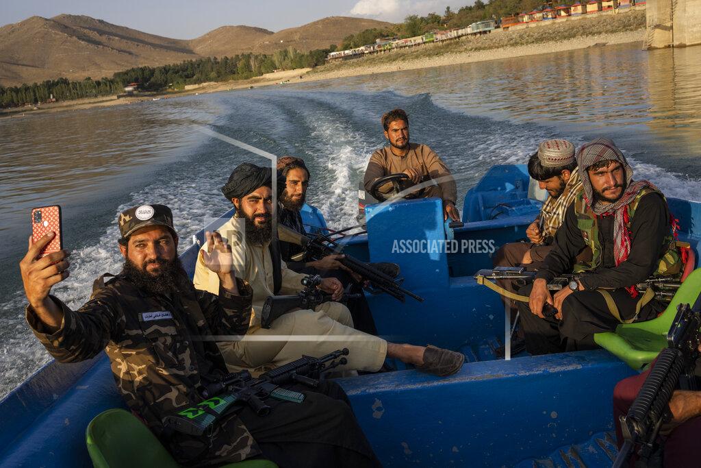Bernat Armangue Taliban fighters enjoy a boat ride in the Qargha dam, outskirt of Kabul, Afghanistan, Friday, Sept. 24, 2021. (AP Photo/Bernat Armangue)