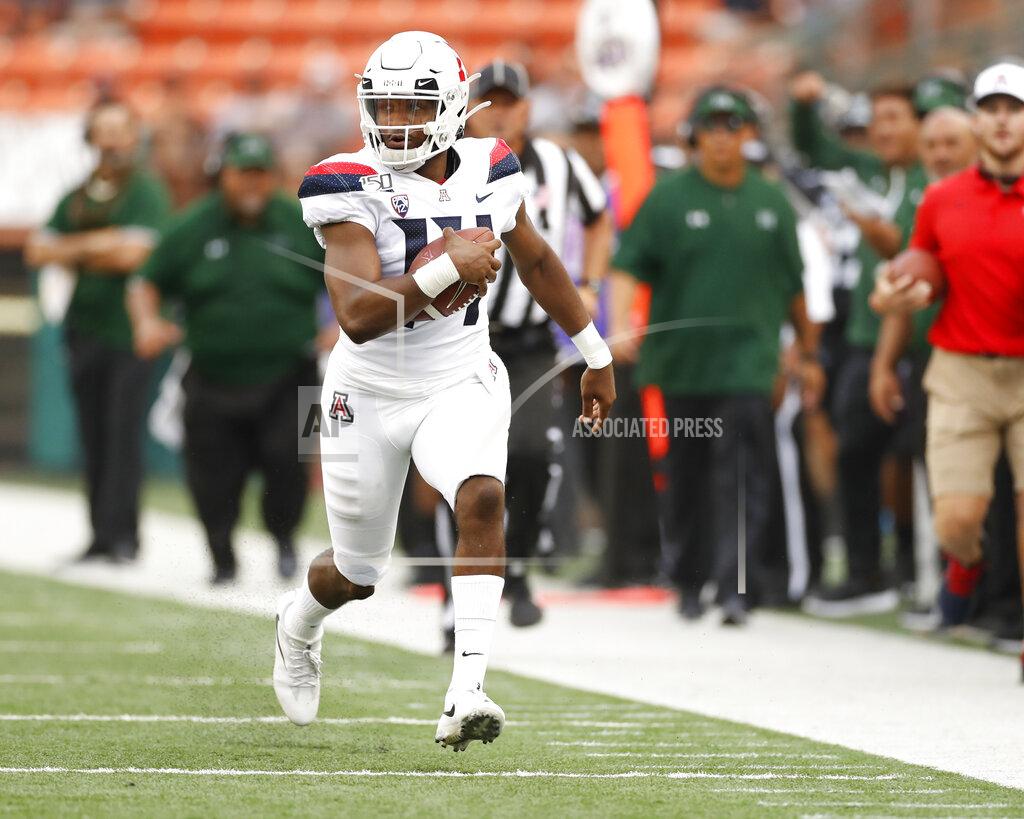 Marco Garcia Arizona quarterback Khalil Tate (14) runs down the sideline during the second quarter during of the team's NCAA college football game against Hawaii on Saturday, Aug. 24, 2019, in Honolulu. (AP Photo/Marco Garcia)