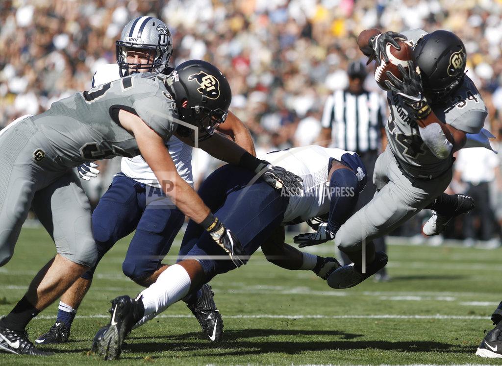David Zalubowski Colorado running back Beau Bisharat, left, pushes New Hampshire linebacker Quinlen Dean, center, as Colorado running back Travon McMillian dives into the end zone for a touchdown in the first half of an NCAA college football game Saturday, Sept. 15, 2018, in Boulder, Colo. (AP Photo/David Zalubowski)