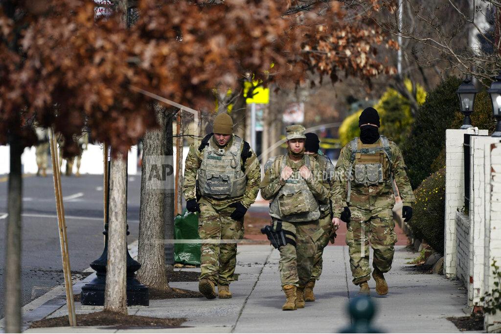 Julio Cortez National Guard walk near the Capitol as security is increased ahead of the inauguration of President-elect Joe Biden and Vice President-elect Kamala Harris, Sunday, Jan. 17, 2021, in Washington, Sunday, Jan. 17, 2021. (AP Photo/Julio Cortez)