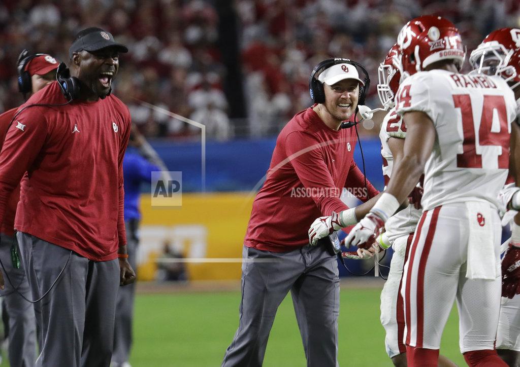 Lynne Sladky Oklahoma head coach Lincoln Riley, center, congratulates wide receiver Charleston Rambo (14) after Rambo scored a touchdowns, during the second half of the Orange Bowl NCAA college football game against Alabama, Saturday, Dec. 29, 2018, in Miami Gardens, Fla. (AP Photo/Lynne Sladky)