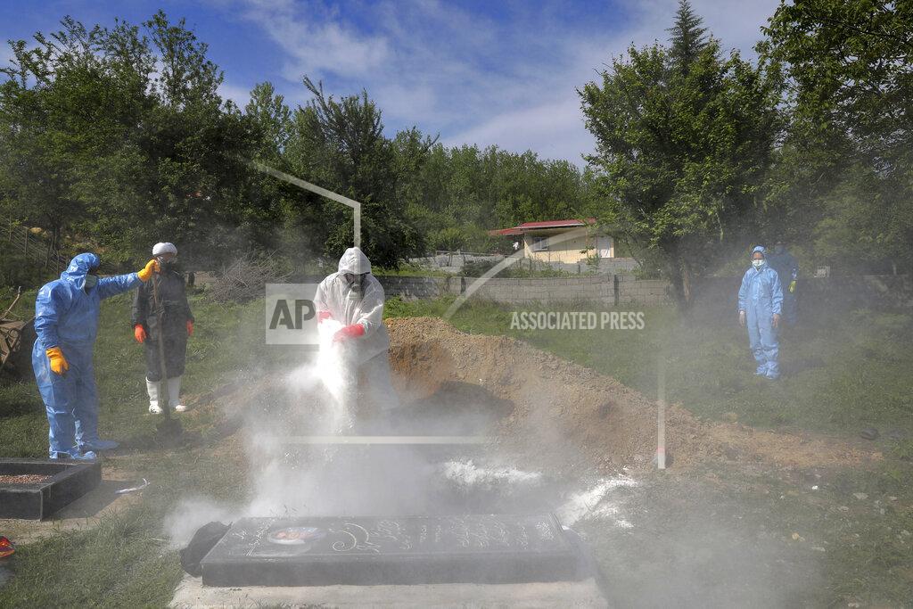 Ebrahim Noroozi People wearing protective clothing attend the funeral of a victim who died from the new coronavirus, at a cemetery in the outskirts of the city of Ghaemshahr in north of Iran, Friday, May 1, 2020. (AP Photo/Ebrahim Noroozi)