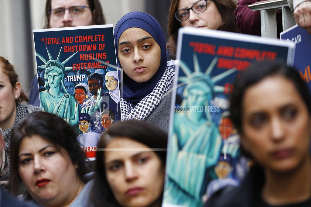 Steve Helber FILE - In this Jan 28, 2020, file photo, demonstrators listen to speakers during a rally outside the U.S. 4th Circuit Court of Appeals in Richmond, Va. Refugee advocates, including faith-based groups that President Donald Trump is courting in his re-election bid, called on Congress Thursday, Oct. 1, to halt his administration’s plans to slash the limit on refugees allowed into the U.S. to a record low, saying it goes against America’s values. (AP Photo/Steve Helber, File)