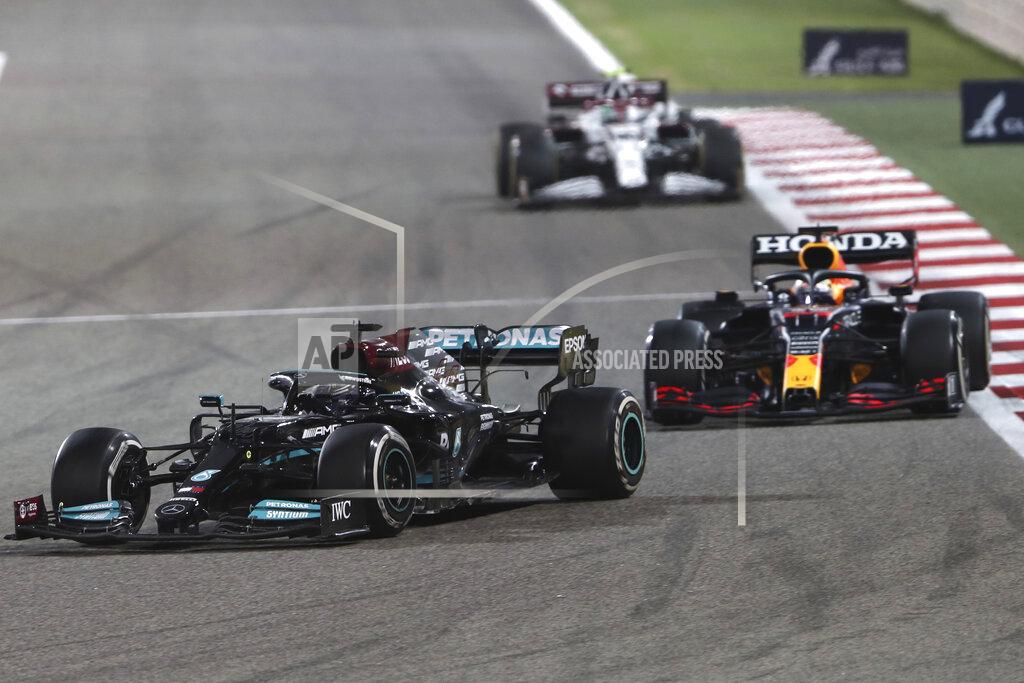 Kamran Jebreili Mercedes driver Lewis Hamilton of Britain steers his car followed by Red Bull driver Max Verstappen of the Netherlands during the Bahrain Formula One Grand Prix at the Bahrain International Circuit in Sakhir, Bahrain, Sunday, March 28, 2021. (AP Photo/Kamran Jebreili)