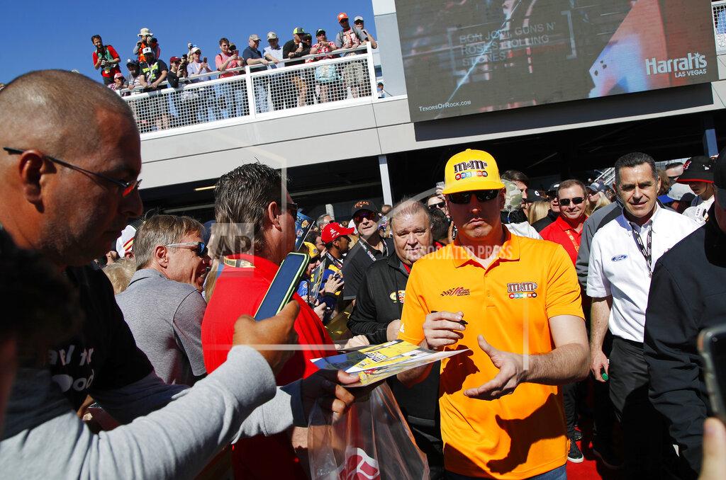 John Locher Kyle Busch, center right, gives autographs to fans before a NASCAR Cup Series auto race at Las Vegas Motor Speedway, Sunday, March 3, 2019, in Las Vegas. (AP Photo/John Locher)