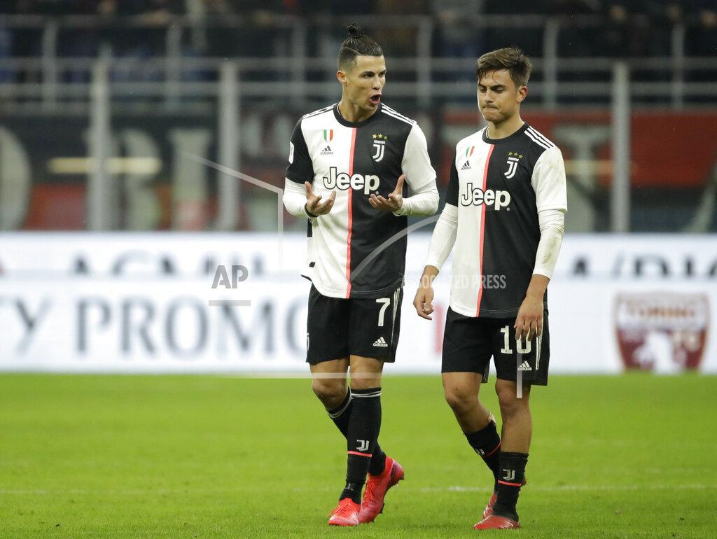Luca Bruno FILE - In this Feb. 13, 2020 file photo, Juventus' Cristiano Ronaldo, left, speaks with Juventus' Paulo Dybala at the end of an Italian Cup soccer match between AC Milan and Juventus at the San Siro stadium, in Milan, Italy. With Inter, Juventus and Milan -- plus Napoli -- all in action when Italian soccer restarts with the Italian Cup semifinals this week, the effects of the pandemic will still be fresh in the minds of players, coaches and club executives. Without fans inside the stadiums, the second-leg matches begin with Juventus hosting Milan on Friday, June 12, 2020, following a 1-1 first leg. (AP Photo/Luca Bruno, file)