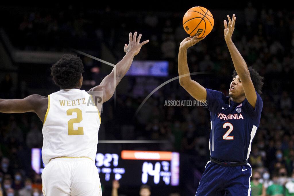 Robert Franklin Virginia's Reece Beekman, right, shoots a 3-pointer over Notre Dame's Trey Wertz during the first half of an NCAA college basketball game Saturday, Jan. 29, 2022, in South Bend, Ind. (AP Photo/Robert Franklin)