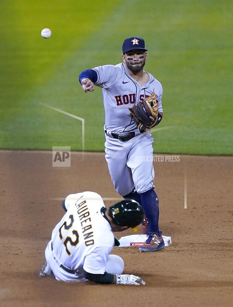 Tony Avelar Houston Astros second baseman Jose Altuve (27) throws to first for the double play on a ball hit by Oakland Athletics' Matt Chapman (not shw=own) after forcing Ramon Laureano (22) out at second during the fourth inning of a baseball game in Oakland, Calif., Thursday, April 1, 2021. (AP Photo/Tony Avelar)