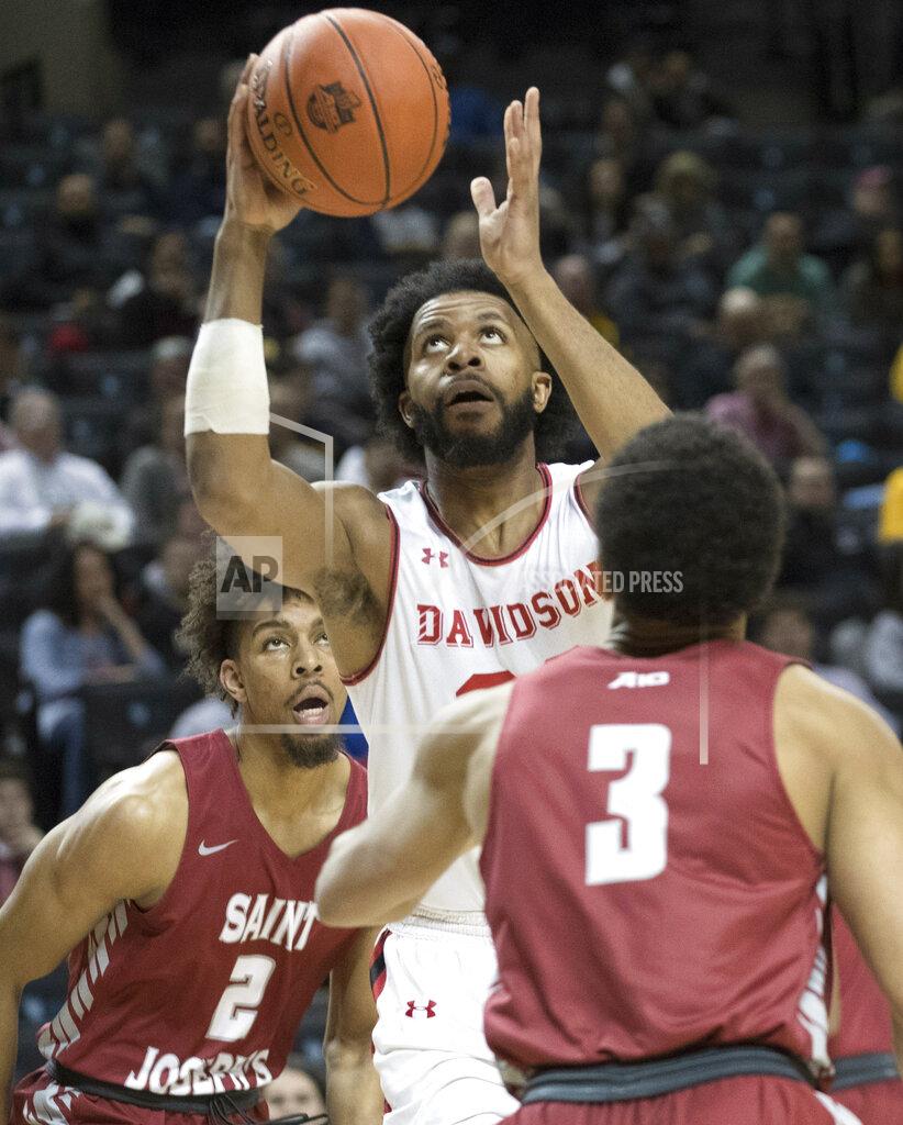Mary Altaffer Davidson guard KiShawn Pritchett, center, goes to the basket against Saint Joseph's guard Jared Bynum (3) and forward Charlie Brown Jr. (2) during the first half of an NCAA college basketball game in the Atlantic 10 Conference tournament, Friday, March 15, 2019, in New York. (AP Photo/Mary Altaffer)