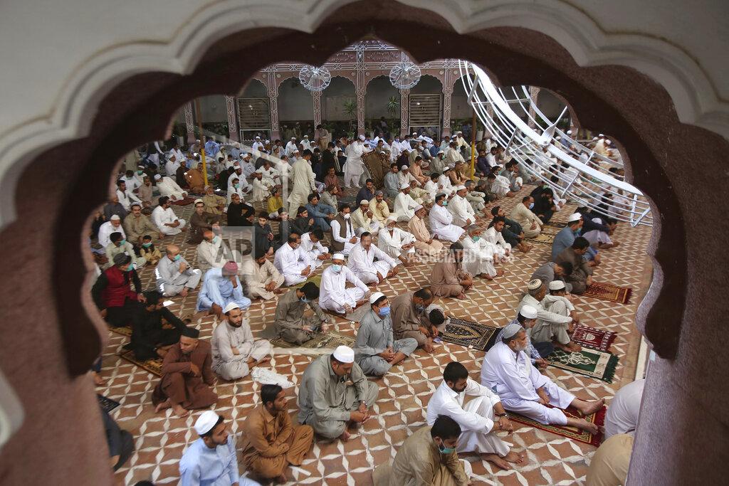 Muhammad Sajjad Muslims offer Eid al-Fitr prayers at a mosque in Peshawar, Pakistan, Sunday, May 24, 2020. Millions of Muslims across the world are marking a muted and gloomy holiday of Eid al-Fitr, the end of the fasting month of Ramadan - a usually joyous three-day celebration that has been significantly toned down as coronavirus cases soar. (AP Photo/Muhammad Sajjad)