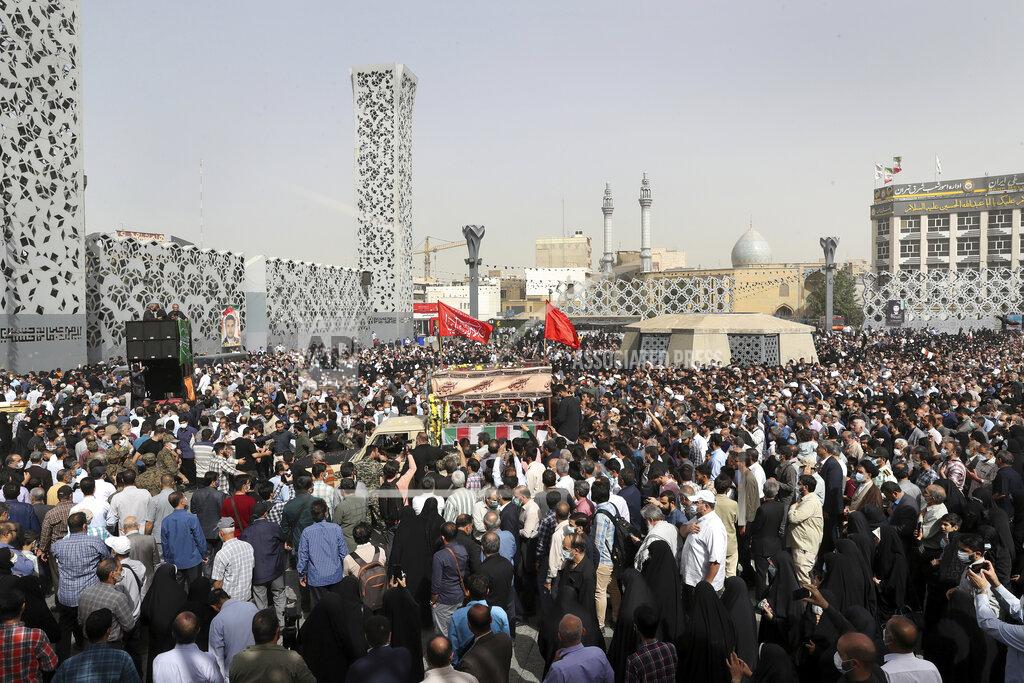 Vahid Salemi Mourners attend the funeral ceremony of Iran's Revolutionary Guard Col. Hassan Sayyad Khodaei who was killed on Sunday, as a truck carries his flag draped coffin, in Tehran, Iran, Tuesday, May 24, 2022. Iran's hard-line President Ebrahim Raisi vowed revenge on Monday over the killing of Sayyad Khodaei who was shot at his car by two assailants outside his home in Tehran, a still-mysterious attack on the country's powerful paramilitary force. (AP Photo/Vahid Salemi)