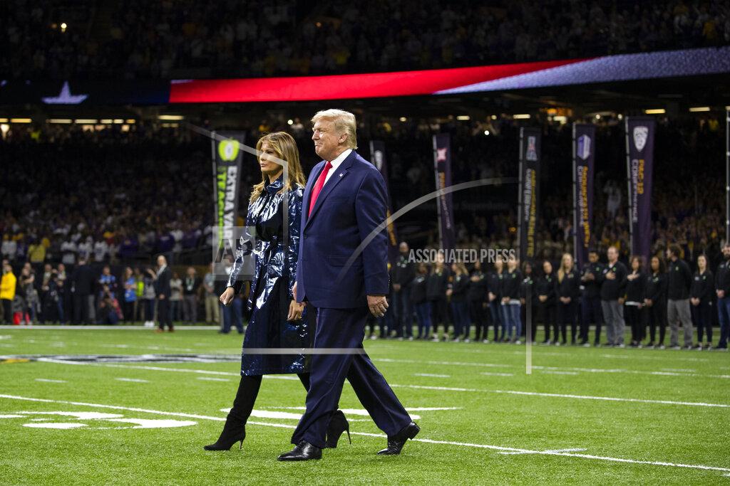 Evan Vucci President Donald Trump and first lady Melania Trump arrive for the College Football Playoff National Championship game between LSU and Clemson, Monday, Jan. 13, 2020, in New Orleans. (AP Photo/ Evan Vucci)