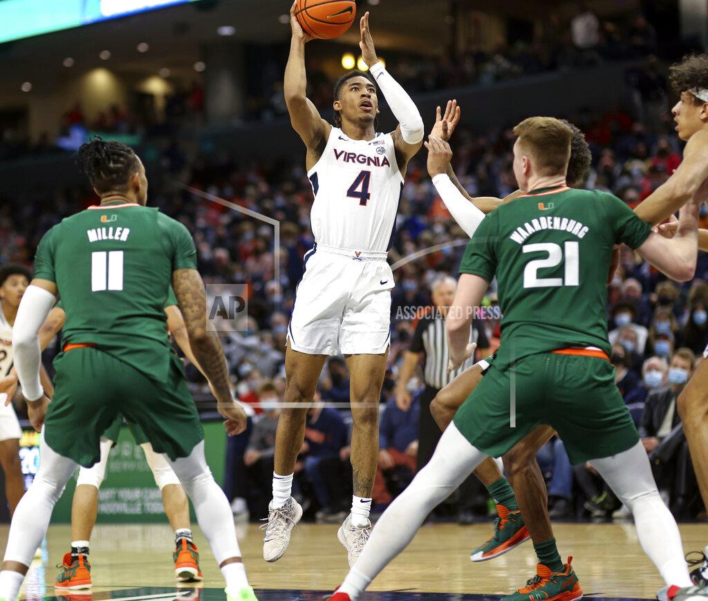Andrew Shurtleff Virginia guard Armaan Franklin (4) shoots between Miami guard Jordan Miller (11) and Miami forward Sam Waardenburg (21) during an NCAA college basketball game in Charlottesville, Va., Saturday, Feb. 5, 2022. (AP Photo/Andrew Shurtleff)