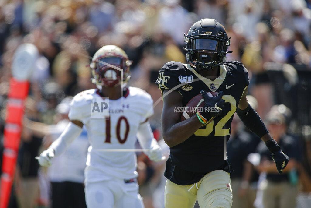 Nell Redmond Wake Forest wide receiver Jaquarii Roberson, right, runs for the end zone to score ahead of Elon defensive back Tre'Von Jones (10) in the first half of an NCAA college football game in Winston-Salem, N.C., Saturday, Sept. 21, 2019. (AP Photo/Nell Redmond)