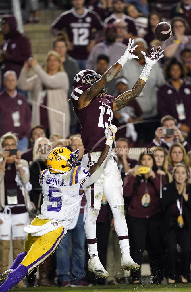David J. Phillip Texas A&M wide receiver Kendrick Rogers (13) catches a touchdown pass as LSU cornerback Kary Vincent Jr. (5) defends during overtime of an NCAA college football game Saturday, Nov. 24, 2018, in College Station, Texas. Texas A&M won 74-72 in seven overtimes.(AP Photo/David J. Phillip)