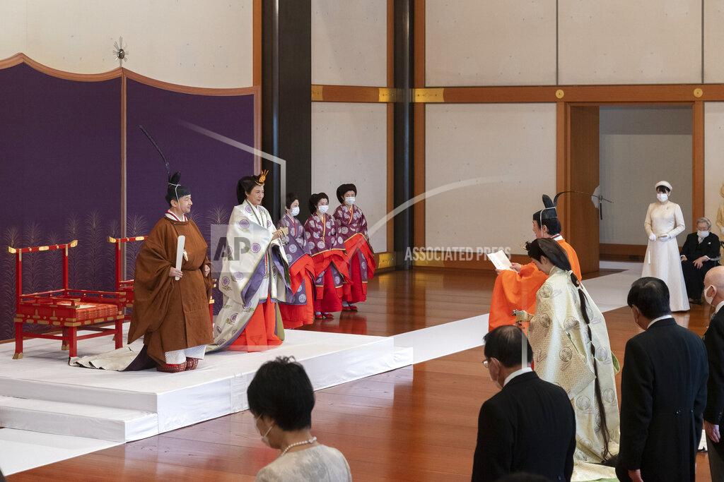 Uncredited In this photo provided by the Imperial Household Agency of Japan, Japan's Crown Prince Akishino, in orange robe, flanked by his wife Crown Princess Kiko, attends a ceremony for formally proclaims Akishino is the first in line to the Chrysanthemum Throne, in front of Emperor Naruhito, left, and Empress Masako, second from left, at the Imperial Palace in Tokyo, Sunday, Nov. 8, 2020. Akishisho, Naruhito's younger brother, was formally sworn in as first in line to the Chrysanthemum Throne in a traditional palace ritual that has been postponed for seven month and scaled down due to the coronavirus pandemic. (Imperial Household Agency of Japan via AP)