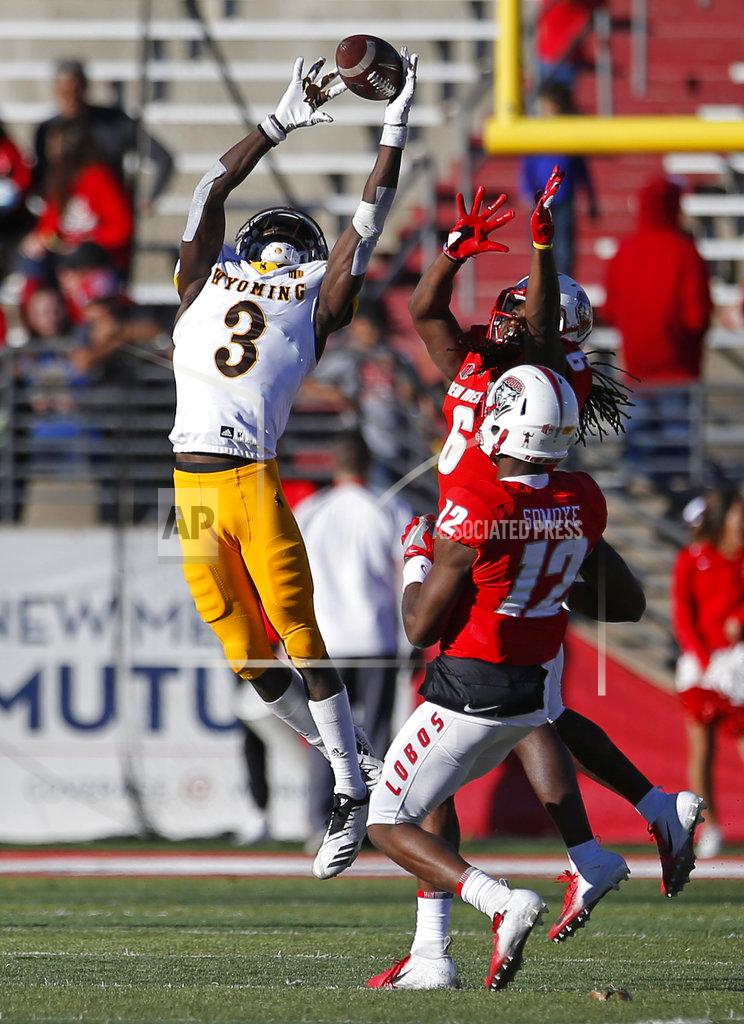 Andres Leighton Wyoming strong safety Alijah Halliburton (3) breaks up a pass intended for New Mexico wide receiver Emmanuel Harris (6) as Anu Somoye (12) looks on during the second half of an NCAA college football game in Albuquerque, N.M., Saturday, Nov. 24, 2018. Wyoming won 31-3. (AP Photo/Andres Leighton)