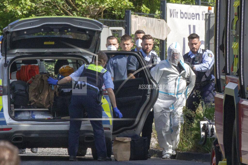 Ralf Roeger Police officers take the suspected perpetrator away in Herzogenrath, Germany, Friday, May 13, 2022. Three passengers on a regional train in Germany overpowered an Iraq-born man who wounded five people with a knife on Friday, authorities said. (Ralf Roeger/dpa via AP)