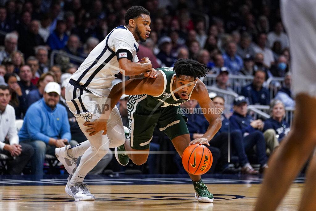Michael Conroy Michigan State guard A.J. Hoggard (11) breaks aways from Butler guard Aaron Thompson (2) in the second half of an NCAA college basketball game in Indianapolis, Wednesday, Nov. 17, 2021. Michigan State defeated Butler 73-52. (AP Photo/Michael Conroy)
