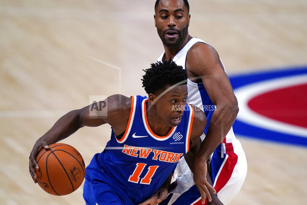 Carlos Osorio New York Knicks guard Frank Ntilikina (11) drives around Detroit Pistons guard Wayne Ellington during the first half of a preseason NBA basketball game Friday, Dec. 11, 2020, in Detroit. (AP Photo/Carlos Osorio)