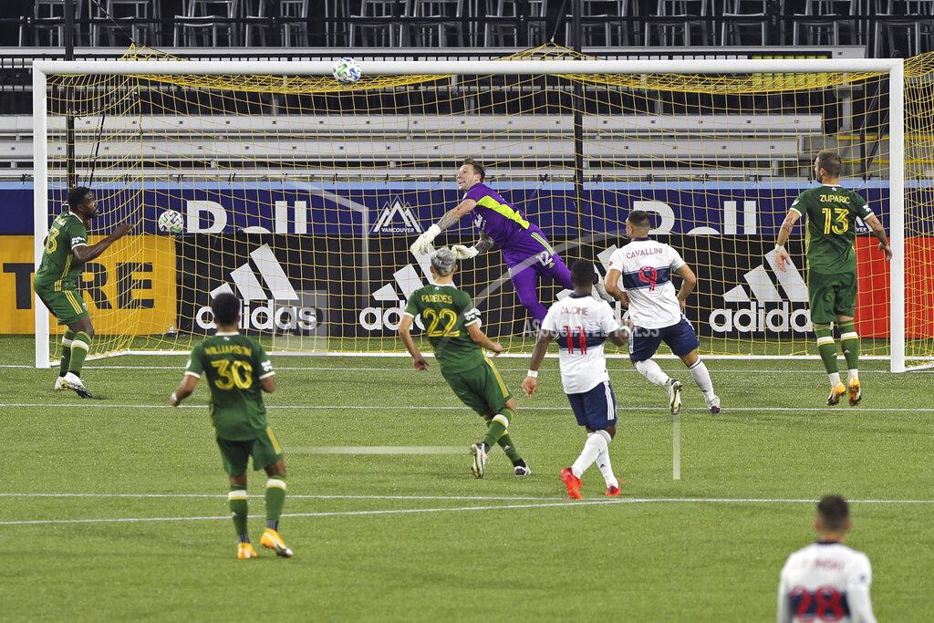 Sean Meagher Portland Timbers goalkeeper Steve Clark makes a save against the Vancouver Whitecaps during an MLS soccer match, Sunday, Sept. 27, 2020, in Portland, Ore. (Sean Meagher/The Oregonian via AP)