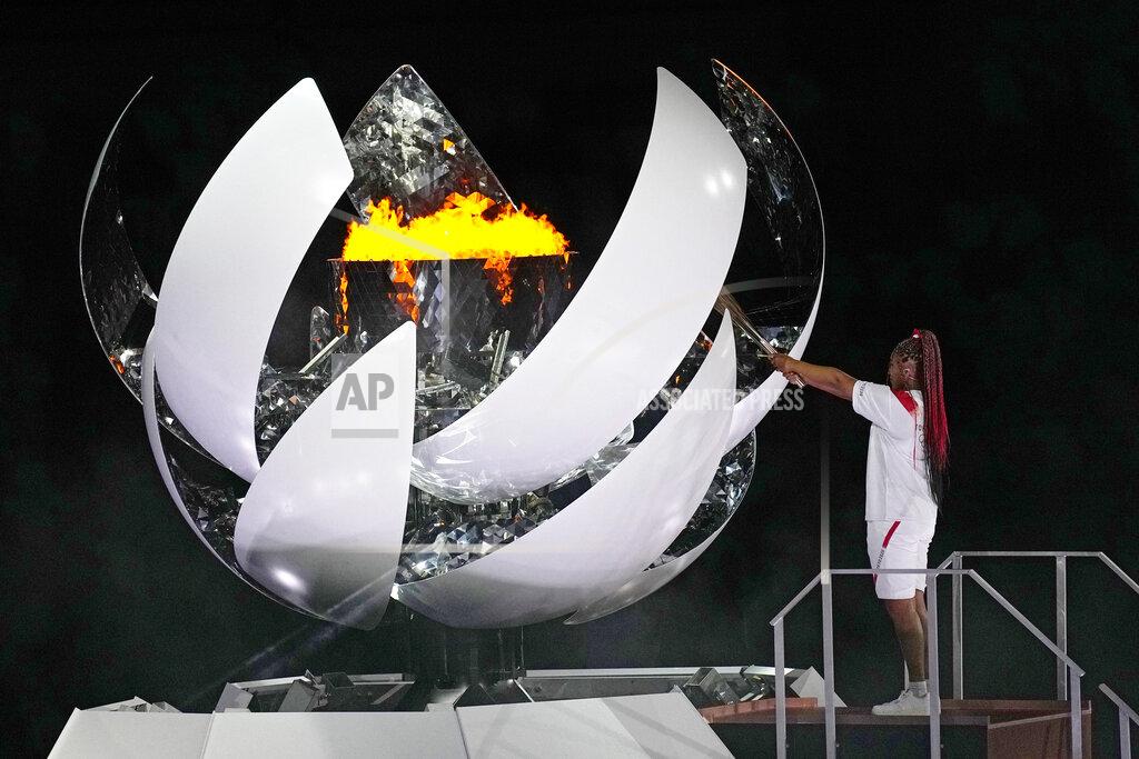 David J. Phillip Naomi Osaka lights the Olympic flame during the opening ceremony in the Olympic Stadium at the 2020 Summer Olympics, Friday, July 23, 2021, in Tokyo, Japan. (AP Photo/David J. Phillip)