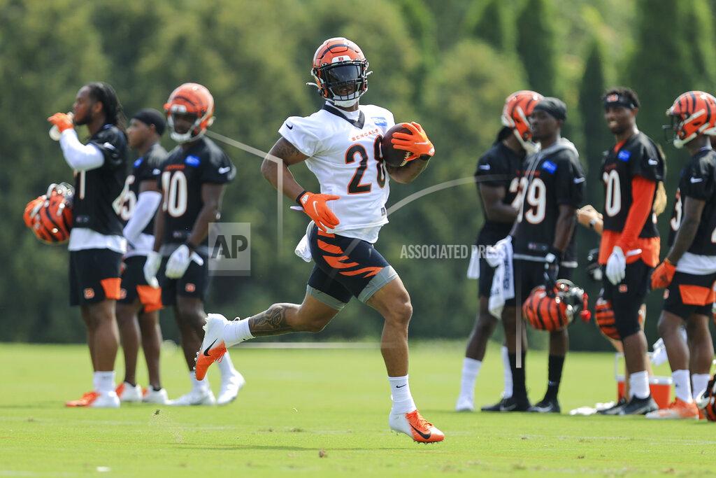 Cincinnati Bengals' Joe Mixon carries the ball during NFL football practice in Cincinnati, Wednesday, July 28, 2021. (AP Photo/Aaron Doster)
