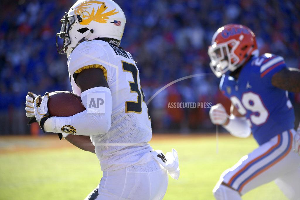 Phelan M. Ebenhack Missouri running back Larry Rountree III (34) runs down the sideline past Florida defensive back Jeawon Taylor (29) for a 27-yard rushing touchdown during the first half of an NCAA college football game Saturday, Nov. 3, 2018, in Gainesville, Fla. (AP Photo/Phelan M. Ebenhack)