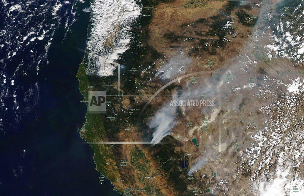 Uncredited This satellite image provided by Satellite image ©2021 Maxar Technologies shows the wildfires in Northern California and Oregon on Wednesday, July 21, 2021. The Oregon fire, which was sparked by lightning, has ravaged the sparsely populated southern part of the state and had been expanding by up to 4 miles (6 kilometers) a day, pushed by strong winds and critically dry weather that turned trees and undergrowth into a tinderbox. (Satellite image ©2021 Maxar Technologies via AP)