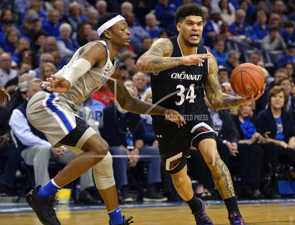 Brandon Dill Cincinnati guard Jarron Cumberland (34) handles the ball against Memphis forward Kyvon Davenport (0) in the first half of an NCAA college basketball game Thursday, Feb. 7, 2019, in Memphis, Tenn. (AP Photo/Brandon Dill)