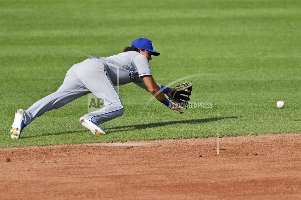 Tony Dejak Kansas City Royals' Nicky Lopez dives for a ball hit by Cleveland Indians' Bradley Zimmer in the third inning in a baseball game, Saturday, July 25, 2020, in Cleveland. Zimmer was safe at first base. (AP Photo/Tony Dejak)