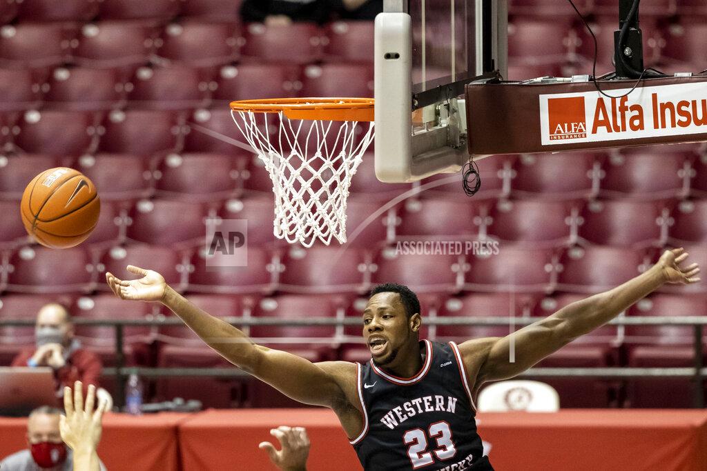 Vasha Hunt Western Kentucky center Charles Bassey (23) reaches for the ball against Alabama during the first half of an NCAA college basketball game, Saturday, Dec. 19, 2020, in Tuscaloosa, Ala. (AP Photo/Vasha Hunt)