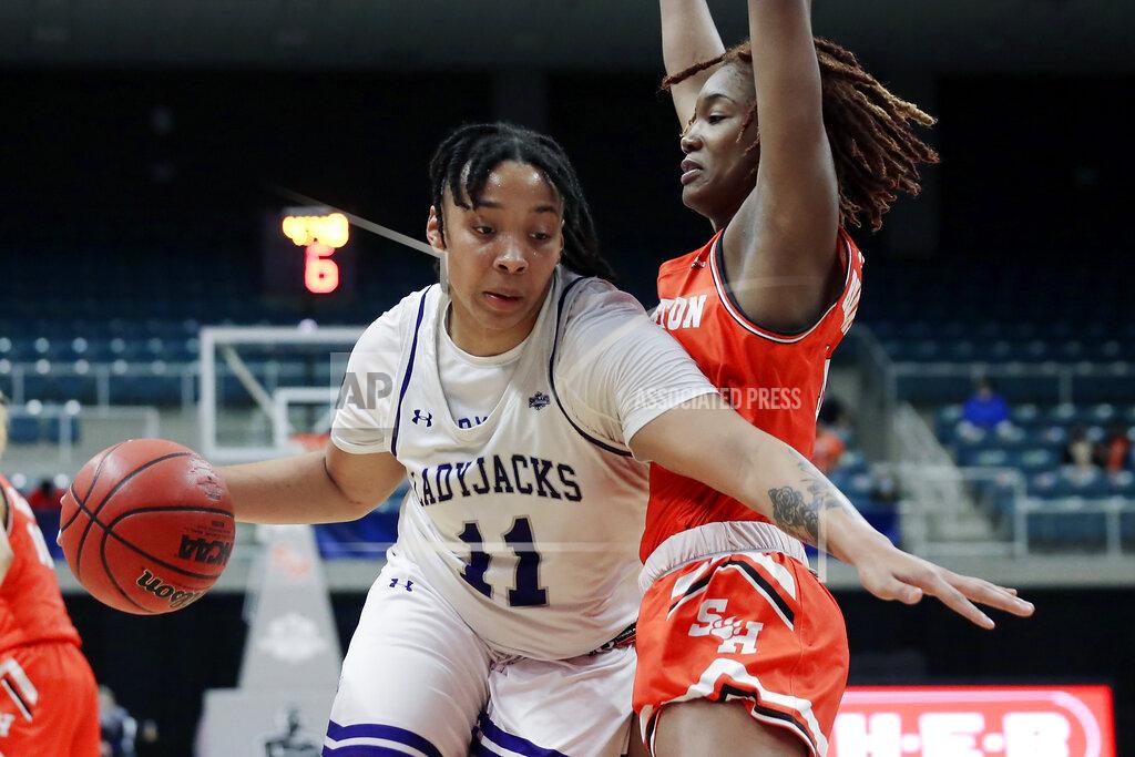 Michael Wyke Stephen F. Austin forward Avery Brittingham (11) drives around Sam Houston State forward Courtney Cleveland, right, during the second half of an NCAA college basketball game for the Southland Conference women's tournament championship Sunday, March 14, 2021, in Katy, Texas. (AP Photo/Michael Wyke)