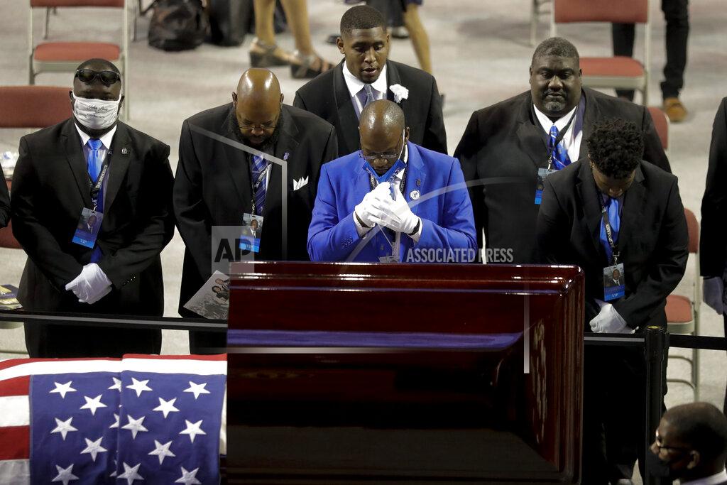 Brynn Anderson Fraternity members sing in front of the casket of the late Rep. John Lewis, D-Ga., during a service celebrating "The Boy from Troy" at Troy University on Saturday, July 25, 2020, in Troy, Ala. Lewis, who carried the struggle against racial discrimination from Southern battlegrounds of the 1960s to the halls of Congress, died Friday, July 17, 2020. (AP Photo/Brynn Anderson)