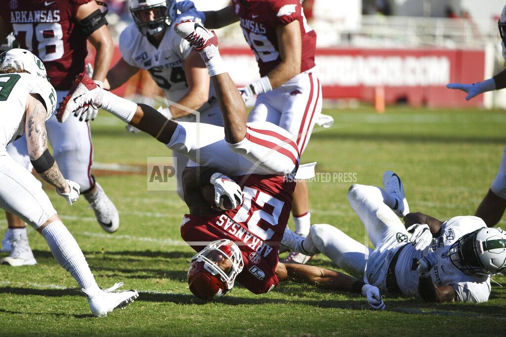 Michael Woods Arkansas running back Devwah Whaley is tripped up by Portland State defender Romeo Gunt during the second half of an NCAA college football game Saturday, Aug. 31, 2019 in Fayetteville, Ark. (AP Photo/Michael Woods)