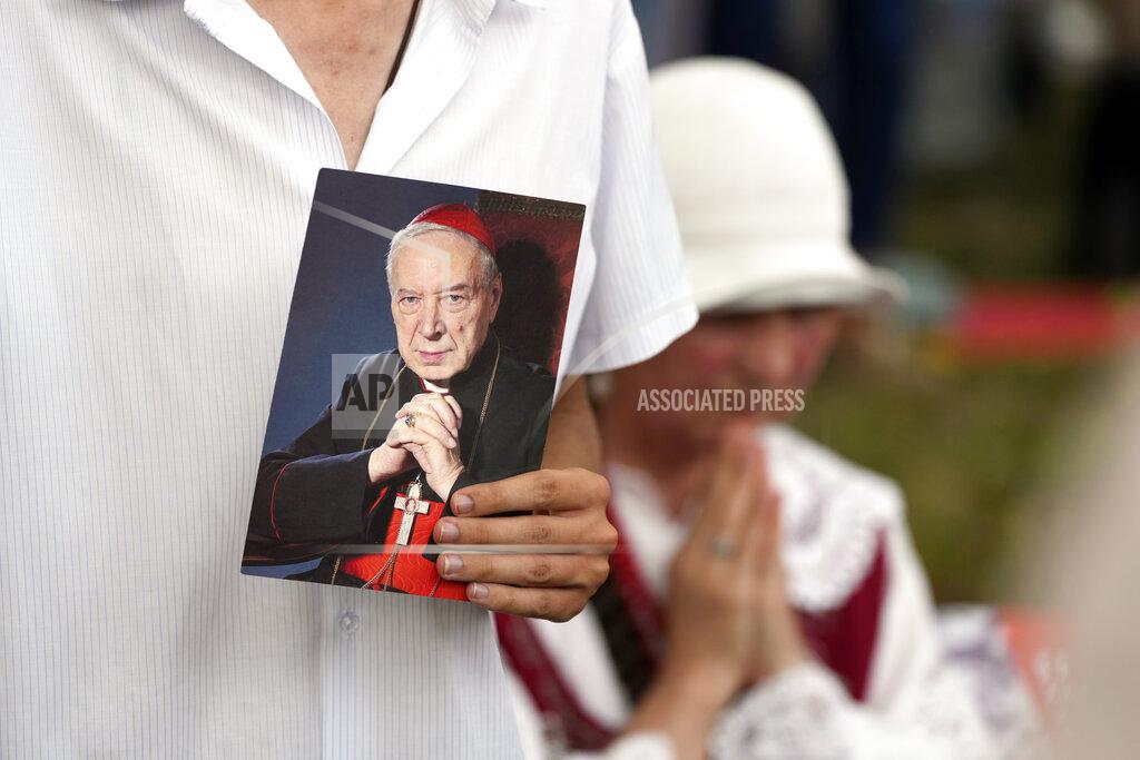 Czarek Sokolowski Catholic faithful attend the beatification ceremony of Polish Cardinal Stefan Wyszynski and Mother Elzbieta Roza Czacka in front of the church of Providence in Warsaw, Poland, Sunday, Sept. 12, 2021. Poland's top political leaders gathered in a Warsaw church Sunday for the beatification of two revered figures of the Catholic church — a cardinal who led the Polish church's resistance to communism and a blind nun who devoted her life to helping others who couldn't see. (AP Photo/Czarek Sokolowski)