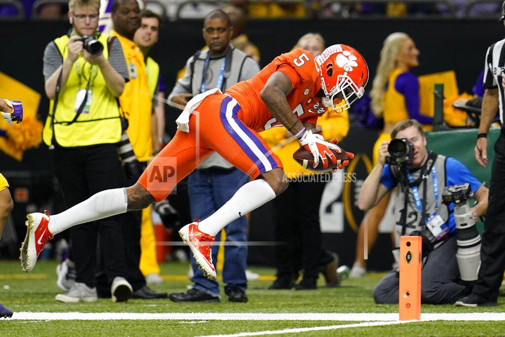 David J. Phillip FILE - In this Jan. 13, 2020, file photo, Clemson wide receiver Tee Higgins scores against LSU during the first half of an NCAA College Football Playoff national championship game in New Orleans. This year’s NFL draft features a superb group of wide receivers, including Higgins, who are expected to make immediate impacts in the NFL. (AP Photo/David J. Phillip, File)