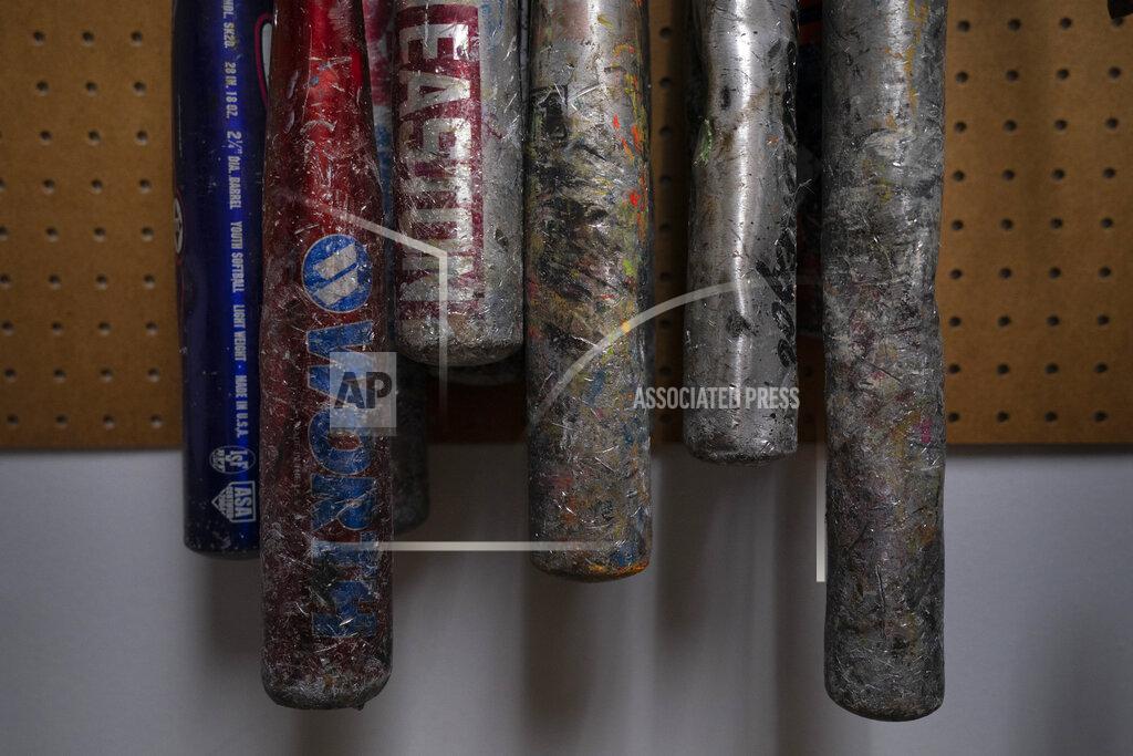 Jae C. Hong Baseball bats hang on a wall for clients to use to destroy objects at Smash RX LLC, Westlake Village, Calif., Friday, Feb. 5, 2021. (AP Photo/Jae C. Hong)
