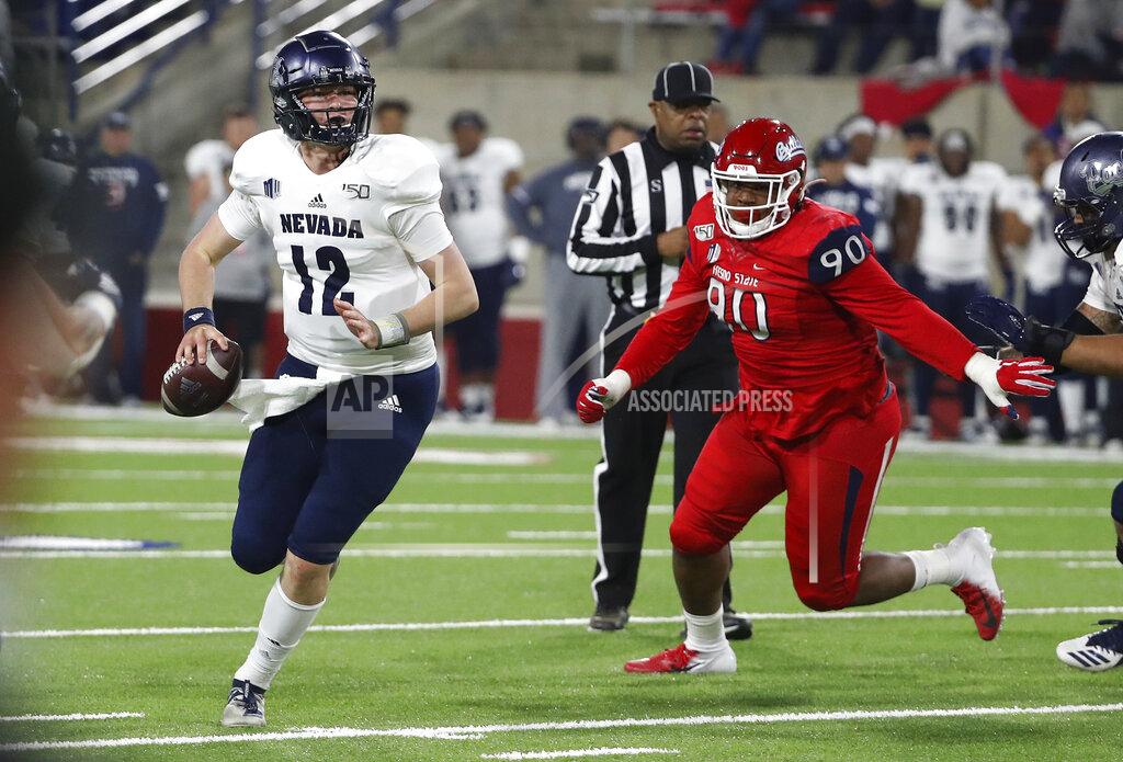 Gary Kazanjian Nevada quarterback Carson Strong rolls out of the pocket as Fresno State defensive tackle Kevin Atkins gives chase during the first half of an NCAA college football game in Fresno, Calif., Saturday, Nov. 23, 2019. (AP Photo/Gary Kazanjian)