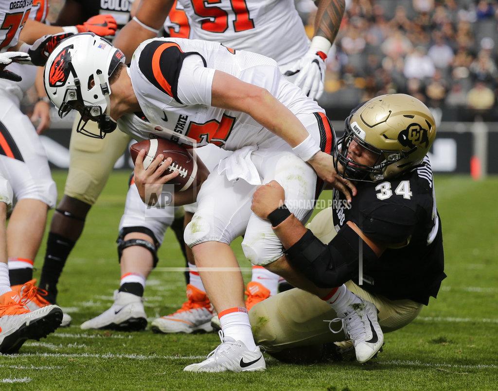 Jack Dempsey Colorado defensive lineman Mustafa Johnson (34) sacks Oregon State quarterback Jack Colletto (12) during the first half of an NCAA college football game, Saturday, Oct. 27, 2018, in Boulder, Colo. (AP Photo/Jack Dempsey)