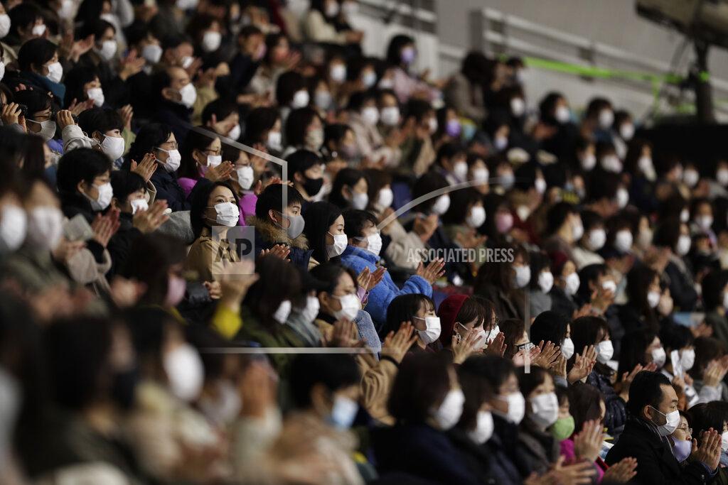 Hiro Komae Spectators wearing face masks watch a skater perform during a free skating of an ISU Grand Prix of Figure Skating competition in Kadoma near Osaka, Japan, Saturday, Nov. 28, 2020. (AP Photo/Hiro Komae)