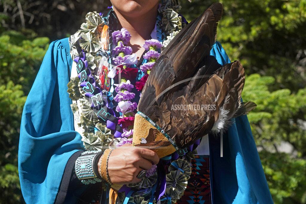 Rick Bowmer Dayne Hudson, member of the Paiute Indian Tribe of Utah, holds his eagle feather fan before the Canyon View High School graduation Wednesday, May 25, 2022, in Cedar City, Utah. Hudson said it was important to wear eagle feathers and a beaded cap to represent his family and honor those who were stopped from doing so under the old rule. (AP Photo/Rick Bowmer)