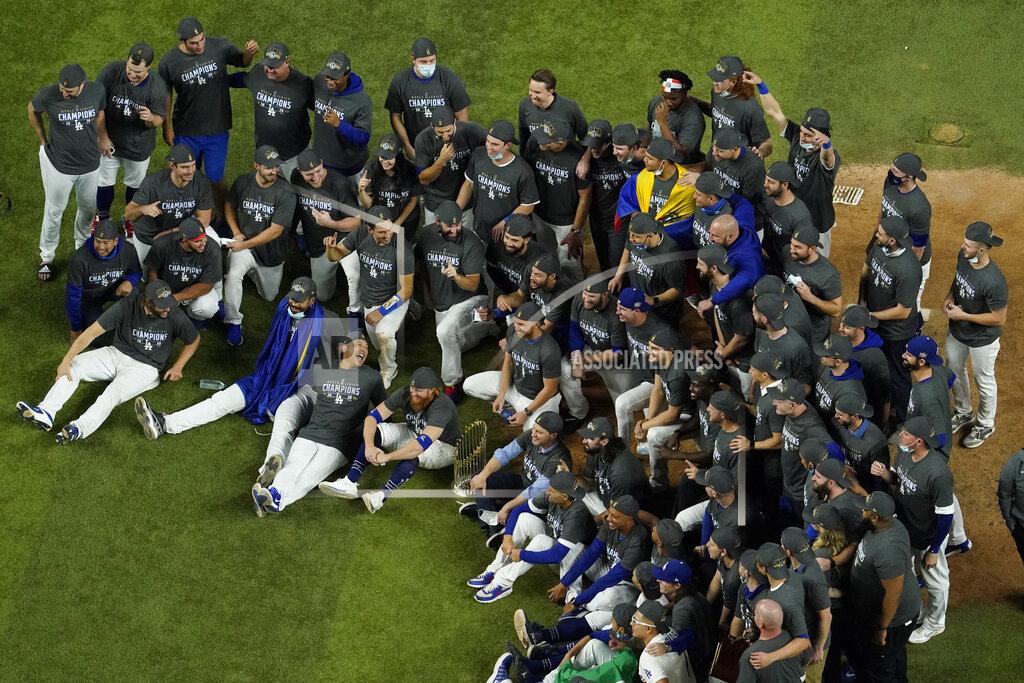 David J. Phillip Los Angeles Dodgers pose for a group picture after defeating the Tampa Bay Rays 3-1 to win the baseball World Series in Game 6 Tuesday, Oct. 27, 2020, in Arlington, Texas. (AP Photo/David J. Phillip)