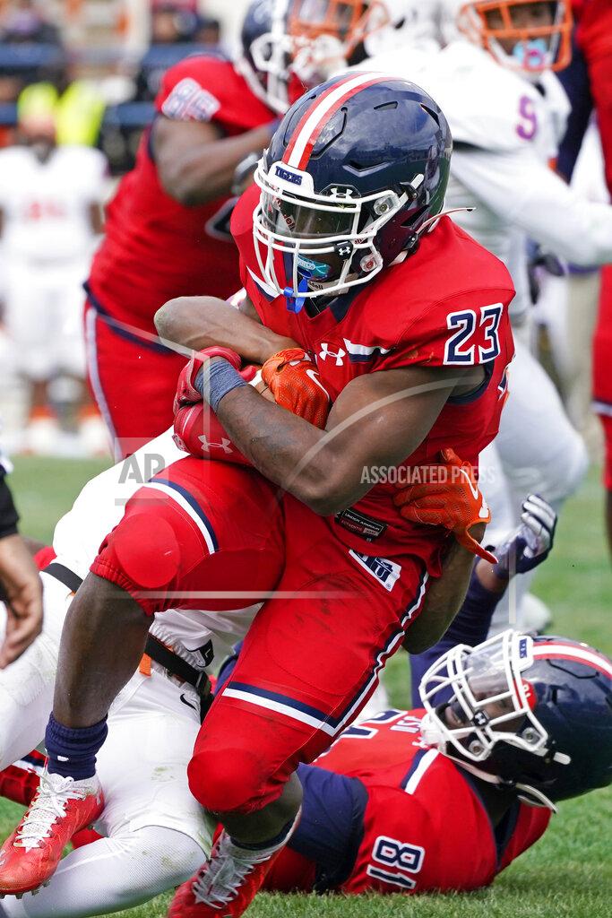 Rogelio V. Solis Jackson State running back Kymani Clarke (23) fights off a tackle attempt by an Edward Waters defender for a touchdown run during the first half of an NCAA college football in Jackson, Miss., Sunday, Feb. 21, 2021. The game marked the head coaching debut of Jackson State football coach Deion Sanders. (AP Photo/Rogelio V. Solis)