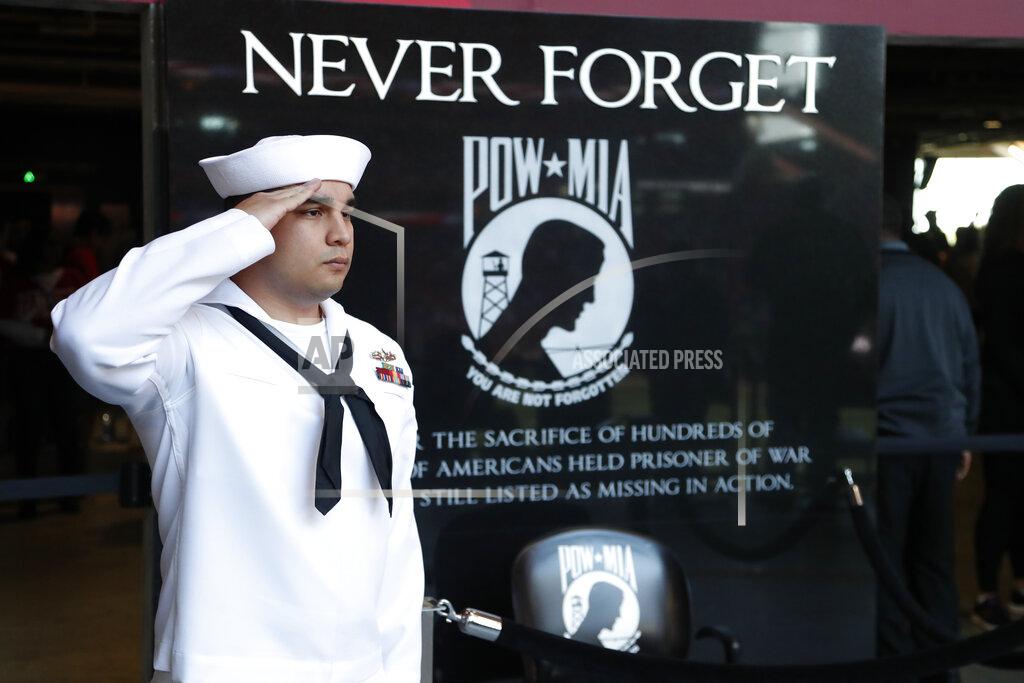 John Bazemore U.S. Navy MM3 Paul Alvaraeo, of Fort Worth Texas, salutes in front of the POW-MIA memorial was at Mercedes-Benz Stadium during the national anthem before the first half of an NFL football game between the Atlanta Falcons and the Seattle Seahawks, Sunday, Oct. 27, 2019, in Atlanta. (AP Photo/John Bazemore)