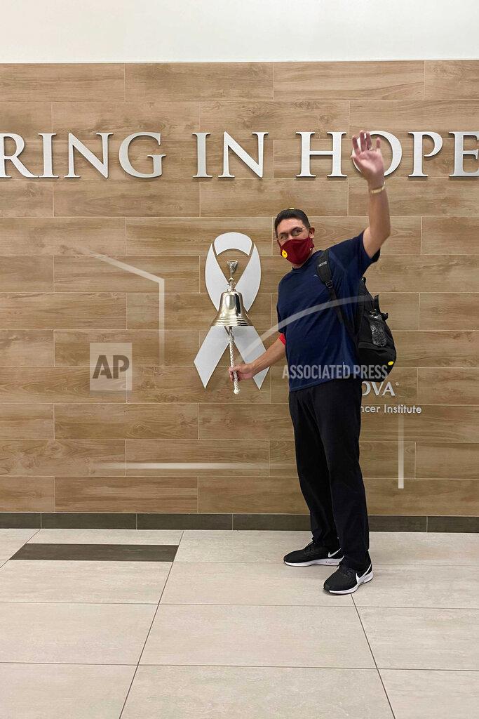 Uncredited In this photo provided by Inova Health System, Washington Football Team NFL football head coach Ron Rivera rings the bell at the Inova Schar Cancer Institute in Fairfax, Va., following his final treatment for a form of skin cancer, on Monday, Oct. 26, 2020. Rivera gets to rest up with the bye week before hosting the New York Giants on Nov. 8. (Inova Health System via AP)
