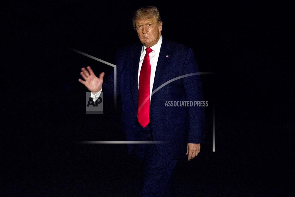 Andrew Harnik President Donald Trump waves to members of the media while walking across the South Lawn of the White House in Washington, Friday, July 10, 2020, as he returns from a trip to Florida. President Donald Trump commuted the sentence of his longtime political confidant Roger Stone on Friday, just days before he was set to report to prison. (AP Photo/Andrew Harnik)
